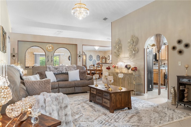 tiled living room featuring an inviting chandelier