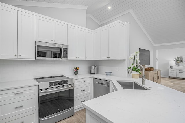 kitchen featuring sink, white cabinetry, stainless steel appliances, and tasteful backsplash