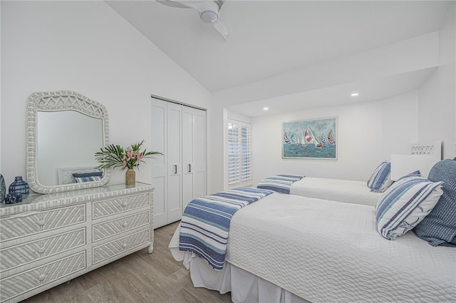 bedroom featuring wood-type flooring, a closet, high vaulted ceiling, and ceiling fan