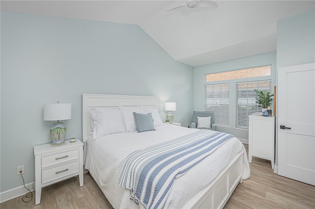 bedroom featuring light wood-type flooring and vaulted ceiling