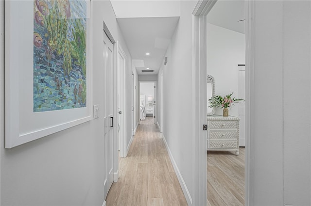 corridor with light hardwood / wood-style flooring