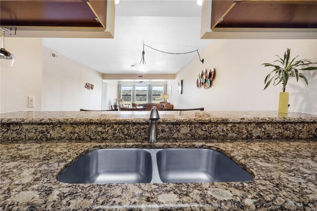 41 Plantation Dr Unit 202, Vero Beach, FL 32966 - kitchen featuring a sink and stone countertops