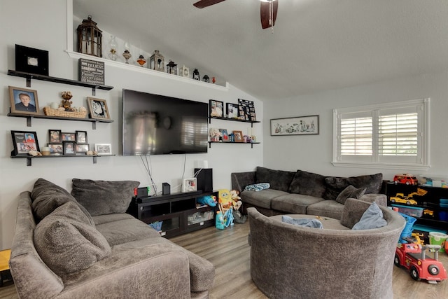 living room with light wood-type flooring, vaulted ceiling, and ceiling fan