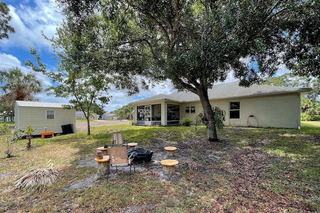 rear view of property with a sunroom