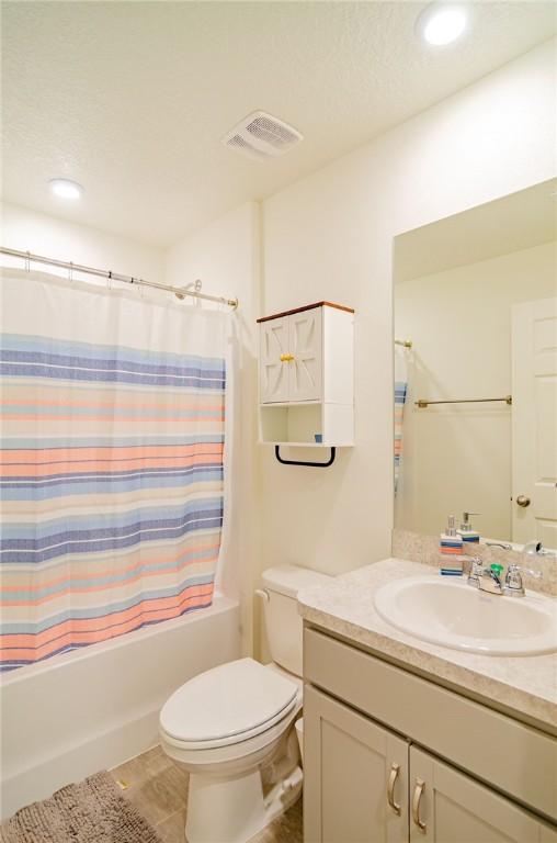 1580 Eastlake Ln, Sebastian, FL 32958 - bathroom with vanity, toilet, shower / tub combo with curtain, and recessed lighting