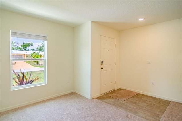 1580 Eastlake Ln, Sebastian, FL 32958 - empty room with baseboards, a textured ceiling, light wood-type flooring, and recessed lighting