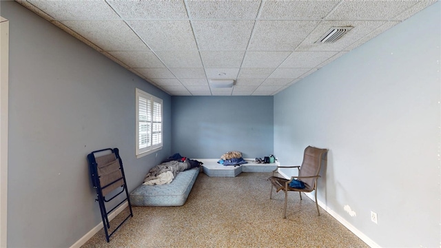 sitting room featuring a drop ceiling