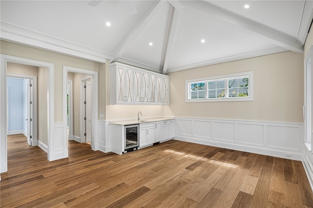 interior space featuring wine cooler, sink, and light hardwood / wood-style floors