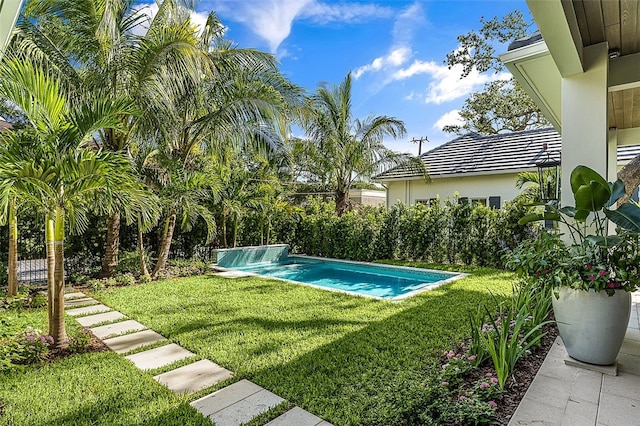 view of swimming pool featuring a lawn