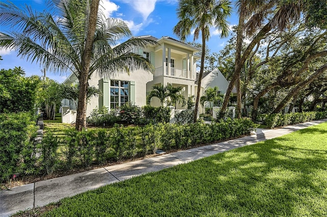 view of home's exterior featuring a yard and a balcony