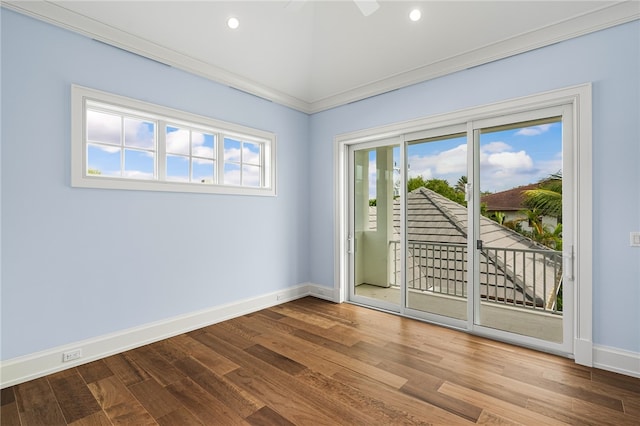 spare room with hardwood / wood-style flooring, ceiling fan, and crown molding