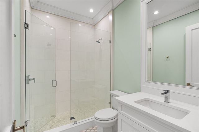 bathroom featuring a shower with door, vanity, toilet, and ornamental molding