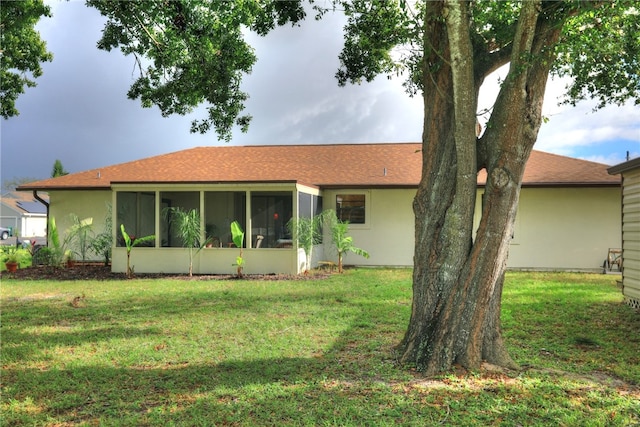 view of front of home with a front lawn and a sunroom