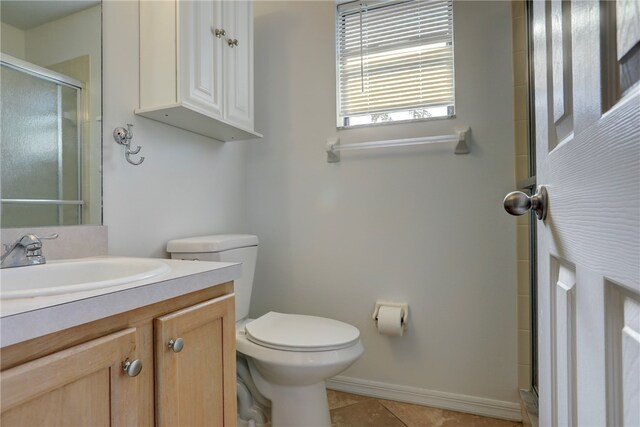 bathroom with toilet, vanity, an enclosed shower, and tile patterned floors