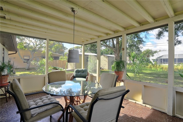 sunroom / solarium with a wealth of natural light and beam ceiling