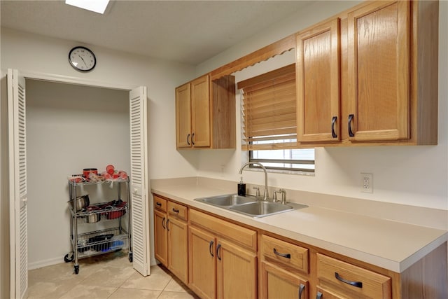 kitchen featuring sink and light tile patterned floors