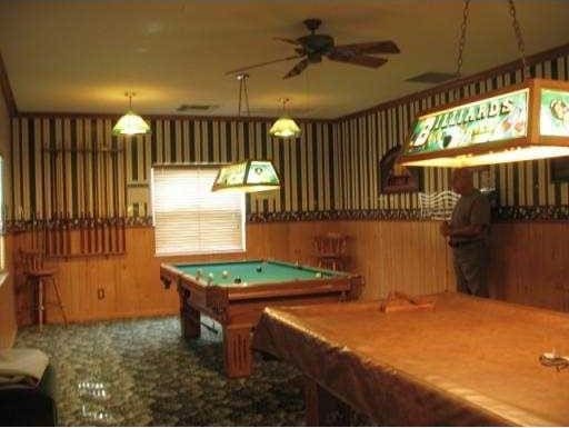 game room with ceiling fan, wood walls, carpet floors, and pool table