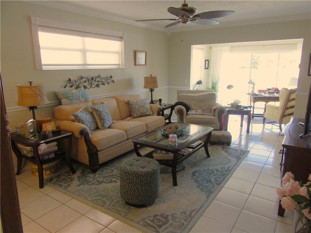 living room with ceiling fan, crown molding, and light tile patterned flooring