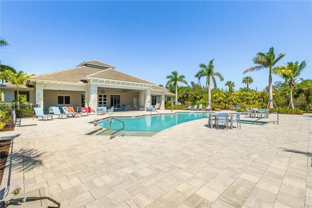 9266 Orchid Cove Cir, Vero Beach, FL 32963 - community pool with a ceiling fan and a patio