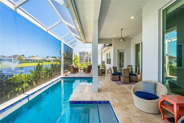 9266 Orchid Cove Cir, Vero Beach, FL 32963 - outdoor pool featuring a patio, ceiling fan, a lanai, and a water view