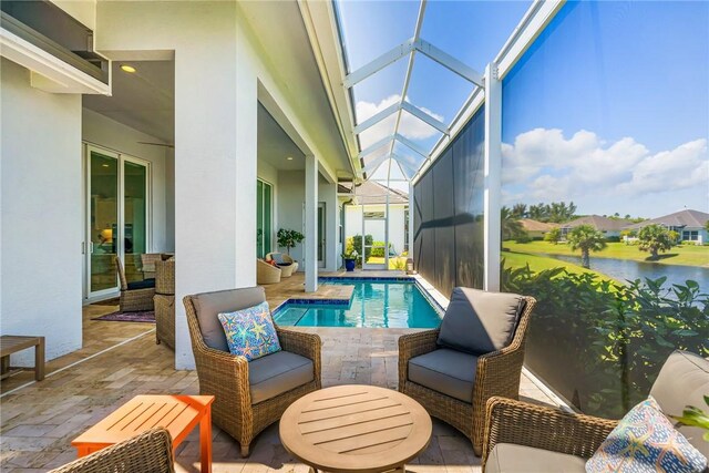 9266 Orchid Cove Cir, Vero Beach, FL 32963 - outdoor pool featuring a patio, glass enclosure, and a water view
