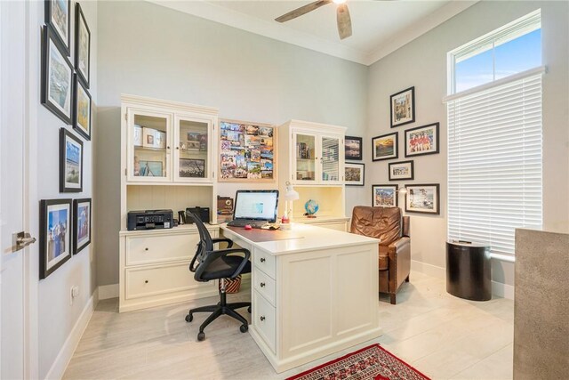 9266 Orchid Cove Cir, Vero Beach, FL 32963 - office featuring a ceiling fan, built in study area, crown molding, light wood-style floors, and a towering ceiling
