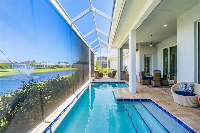 9266 Orchid Cove Cir, Vero Beach, FL 32963 - outdoor pool with a patio area, a water view, an outdoor hangout area, a lanai, and a ceiling fan
