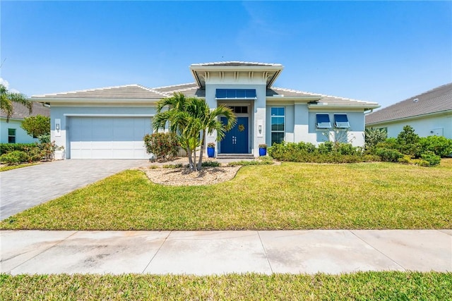 9266 Orchid Cove Cir, Vero Beach, FL 32963 - view of front of property featuring stucco siding, a garage, a front lawn, and decorative driveway