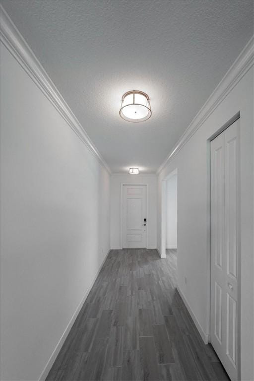 3544 Angler Dr, Fort Pierce, FL 34946 - hallway with dark wood-style floors, a textured ceiling, and ornamental molding