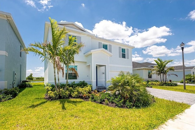3544 Angler Dr, Fort Pierce, FL 34946 - view of front of house featuring a front yard, stucco siding, and a garage