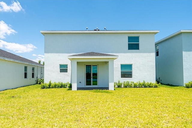 3544 Angler Dr, Fort Pierce, FL 34946 - back of property featuring stucco siding and a yard
