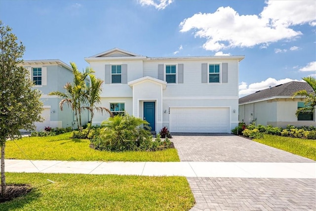 3544 Angler Dr, Fort Pierce, FL 34946 - view of front facade with a garage, decorative driveway, a front lawn, and stucco siding