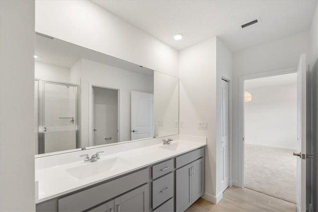 3544 Angler Dr, Fort Pierce, FL 34946 - full bathroom with double vanity, a stall shower, and wood finished floors