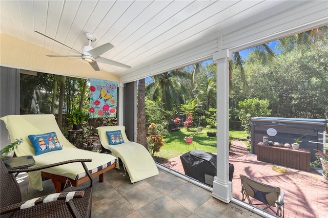 sunroom with ceiling fan and wooden ceiling