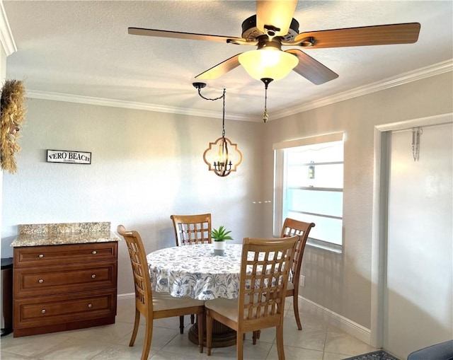 tiled dining area featuring crown molding and ceiling fan with notable chandelier