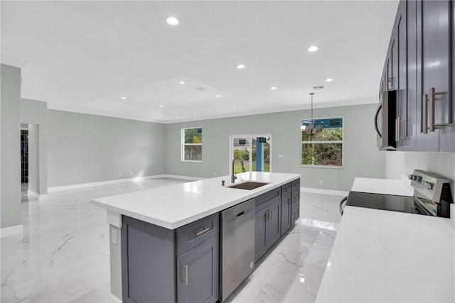 kitchen with gray cabinetry, a center island with sink, sink, hanging light fixtures, and stainless steel appliances