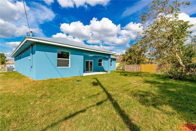 rear view of property featuring a lawn