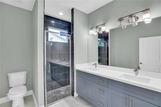 bathroom with a shower with door, vanity, and toilet