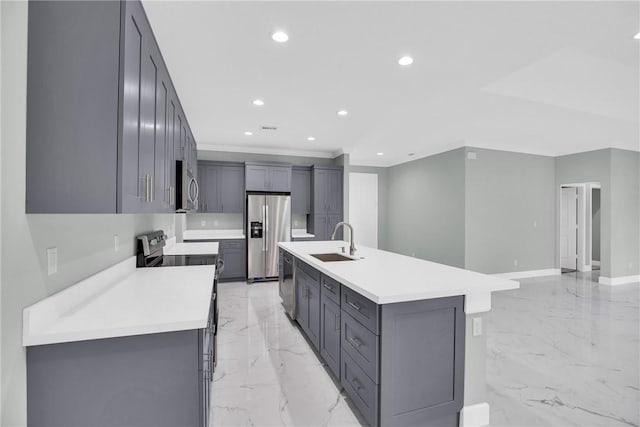 kitchen with gray cabinets, sink, an island with sink, and appliances with stainless steel finishes