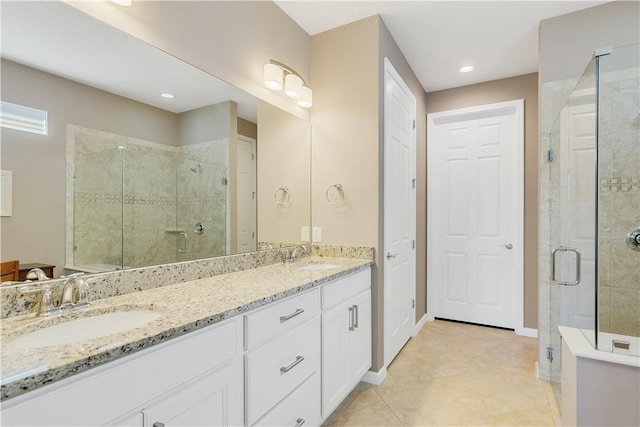 bathroom with vanity, tile patterned floors, and a shower with shower door