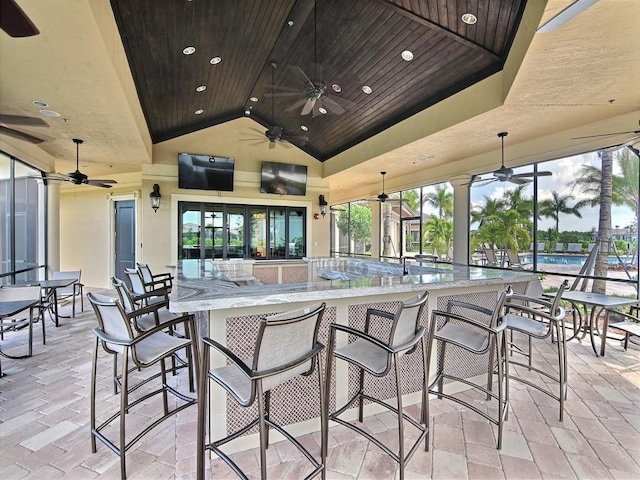 view of patio / terrace featuring exterior bar and ceiling fan