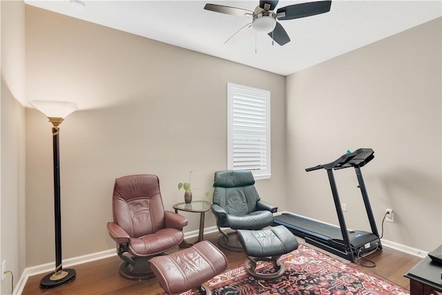 living area featuring hardwood / wood-style flooring and ceiling fan