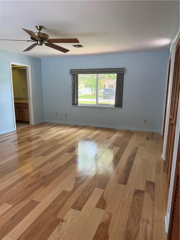 2525 84th Ter, Vero Beach, FL 32966 - unfurnished bedroom with light wood-style floors, a closet, and a ceiling fan