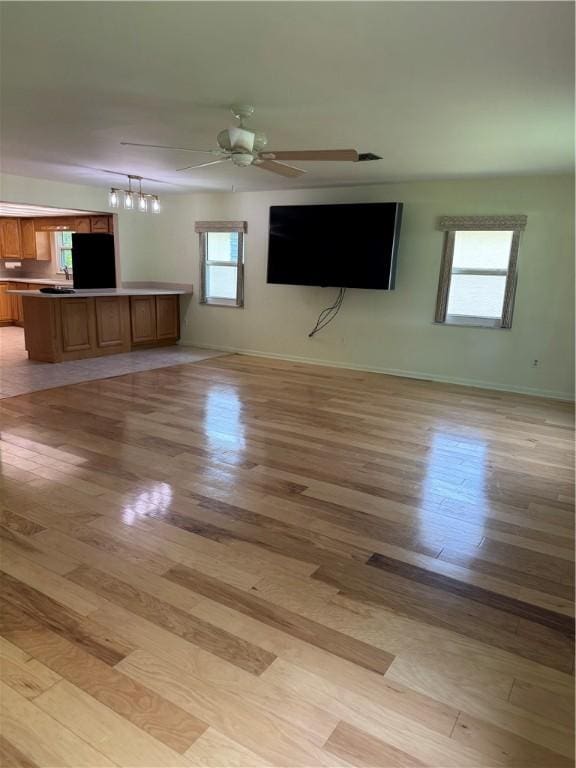 2525 84th Ter, Vero Beach, FL 32966 - unfurnished living room featuring light wood-style floors and a ceiling fan