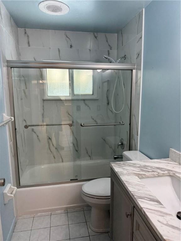 2525 84th Ter, Vero Beach, FL 32966 - bathroom with bath / shower combo with glass door, vanity, and tile patterned flooring