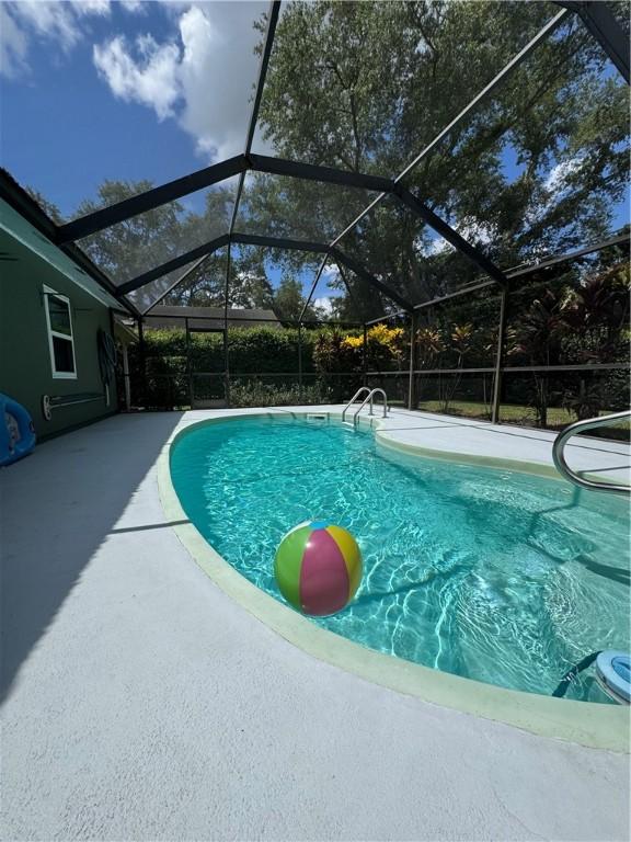 2525 84th Ter, Vero Beach, FL 32966 - outdoor pool with a patio area and glass enclosure