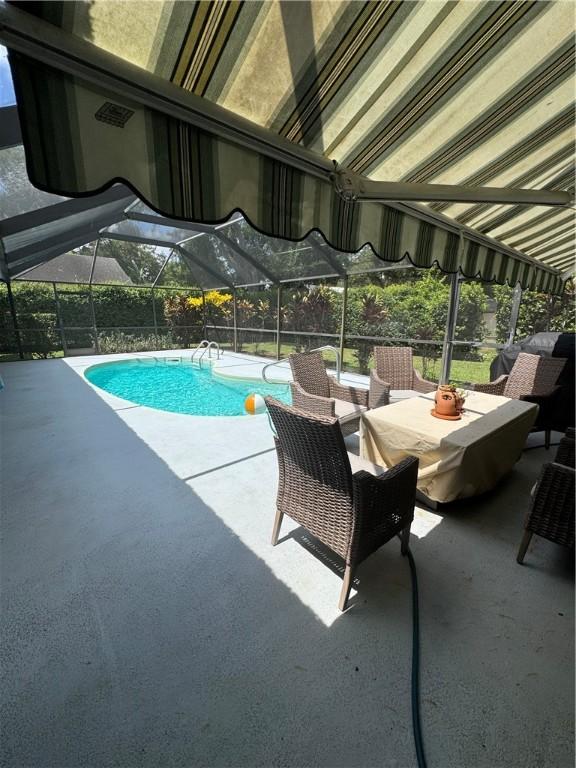 2525 84th Ter, Vero Beach, FL 32966 - view of pool with a patio area, an outdoor living space, and a lanai