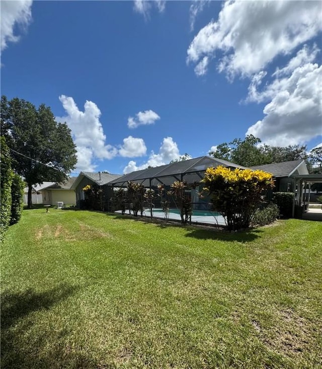 2525 84th Ter, Vero Beach, FL 32966 - view of grassy yard with an outdoor pool and a lanai