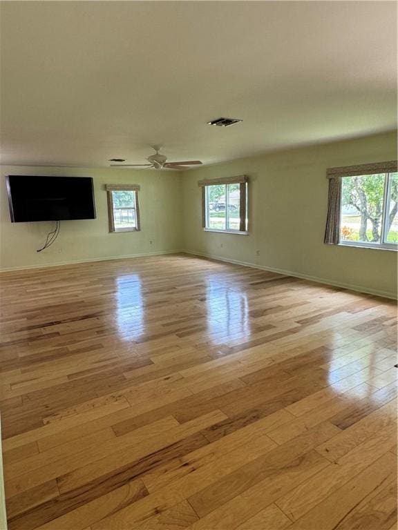 2525 84th Ter, Vero Beach, FL 32966 - unfurnished living room with light wood-type flooring, healthy amount of natural light, and ceiling fan