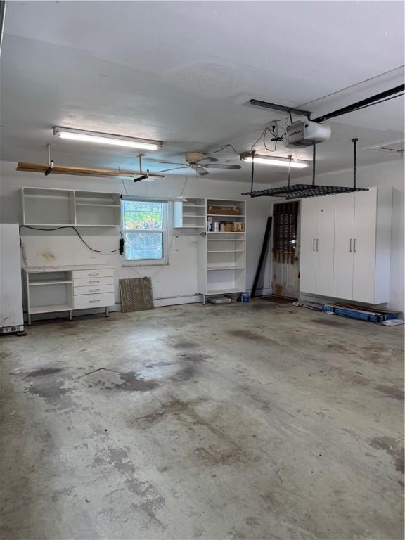 2525 84th Ter, Vero Beach, FL 32966 - garage featuring a garage door opener and refrigerator